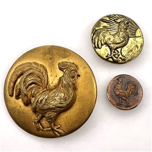 Three metal buttons of roosters.