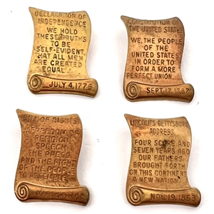 Set of four brass scroll declaration etc. buttons.