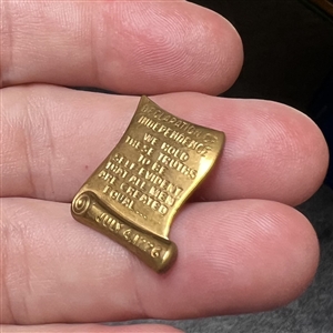 Set of four brass scroll declaration etc. buttons.