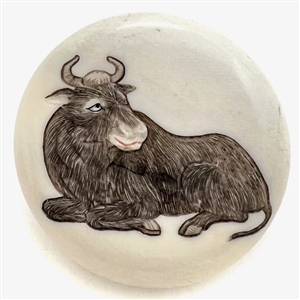 Incised and inked natural material button an ox. 