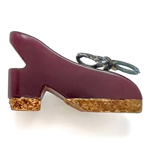 Vintage Bakelite button of a realistic shoe with cork and painted rope.