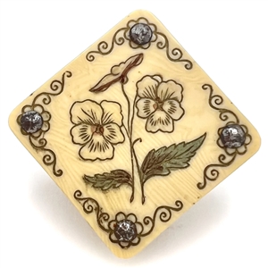 Incised and inked Ivorine wafer button of pansies with cut-steels.