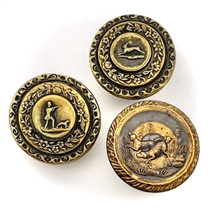 Three brass sporting target buttons.