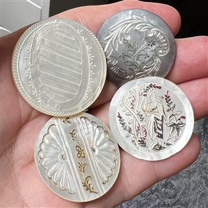 Four 19th c. Pearl and shell buttons including a woman picking fruit.