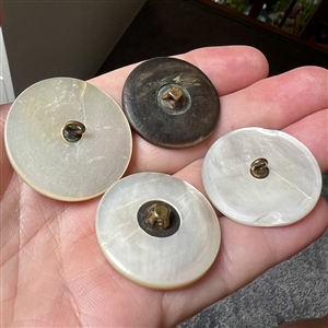 Four 19th c. Pearl and shell buttons including a woman picking fruit.