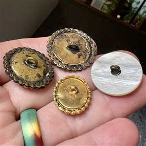 Four cameo carved pearl and shell buttons.