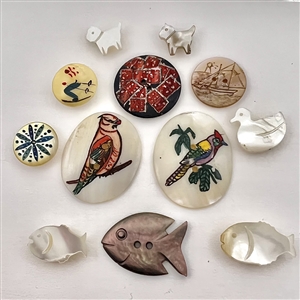 Twelve pictorial pearl and shell buttons.