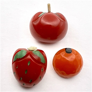 Three vintage Bakelite buttons of fruit.
