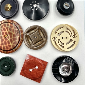 Card of twenty large vintage celluloid, casein and plastic buttons. 