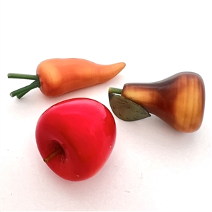 Three vintage celluloid buttons of fruits and veggies.