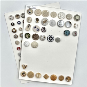 Two cards of 98 white, caramel and clear glass buttons.