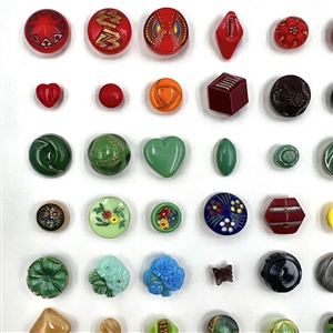 Two cards of 151 clear and colored glass buttons. 
