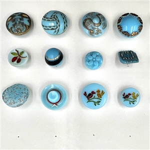 Two cards of 104 clear and colored glass buttons. 