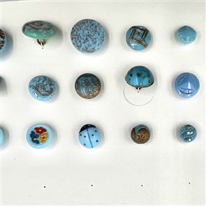 Two cards of 104 clear and colored glass buttons. 