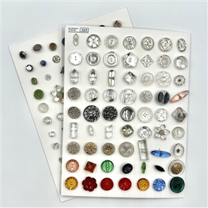 Two cards of mostly clear glass buttons.