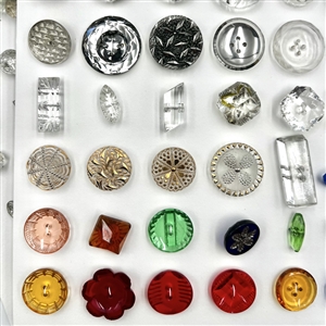 Two cards of mostly clear glass buttons.