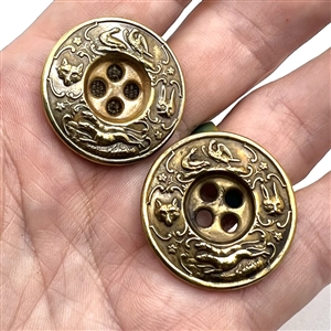 Two very unusual sporting target sew-thru buttons.