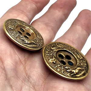 Two very unusual sporting target sew-thru buttons.