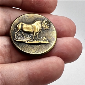 Exotic sporting button of a gnu (African antelope).