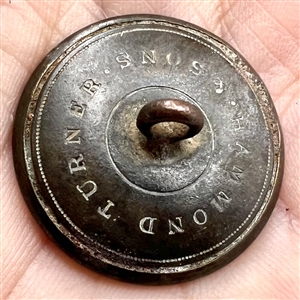 Exotic sporting button of a gnu (African antelope).