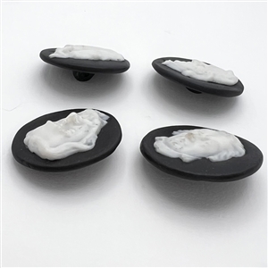 Four jasperware buttons of famous composers.