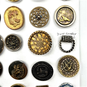 Card of 35 assorted pictorial metal buttons.