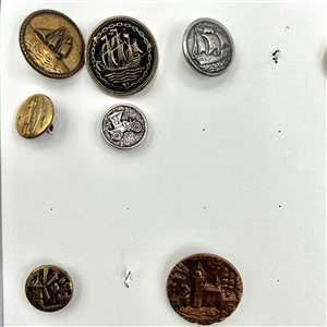 Two cards of 64 animal and other metal pictorial  buttons. 