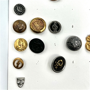 Two cards of 64 animal and other metal pictorial  buttons. 