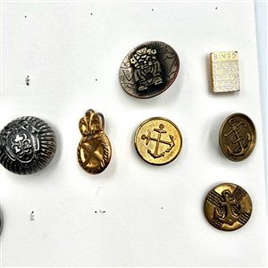 Two cards of 64 animal and other metal pictorial  buttons. 