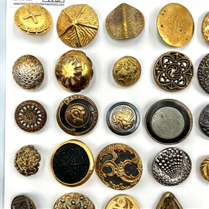 Three cards of 137 assorted metal buttons. 