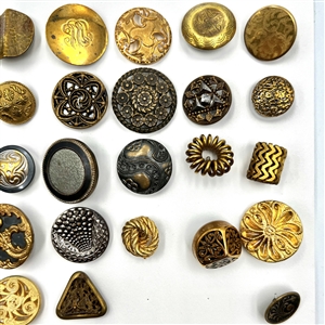 Three cards of 137 assorted metal buttons. 
