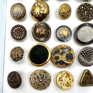 Three cards of 137 assorted metal buttons. 