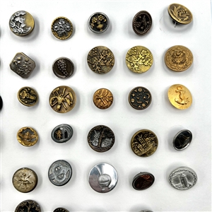 Card of 87 small metal picture buttons. 