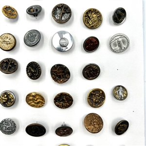 Card of 87 small metal picture buttons. 