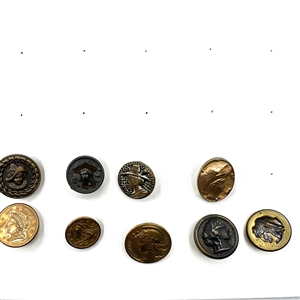 Two cards of 99 metal picture buttons. 