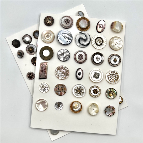 Two cards of 63 pearl and shell buttons. 