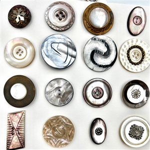 Two cards of 63 pearl and shell buttons. 
