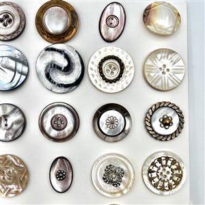 Two cards of 63 pearl and shell buttons. 