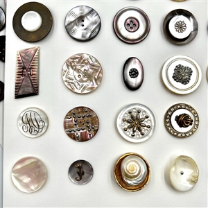 Two cards of 63 pearl and shell buttons. 