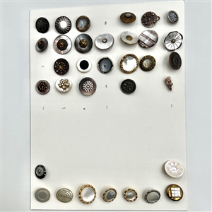Two cards of 63 pearl and shell buttons. 