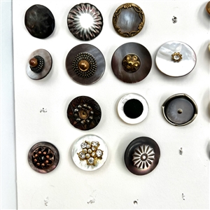 Two cards of 63 pearl and shell buttons. 