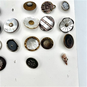 Two cards of 63 pearl and shell buttons. 