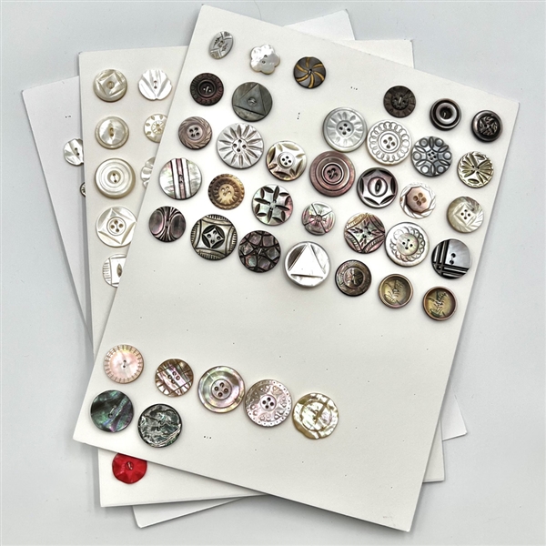 Three cards of 133 pearl and shell buttons. 