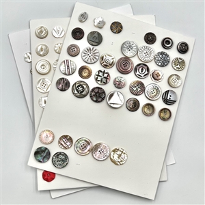 Three cards of 133 pearl and shell buttons. 