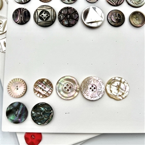 Three cards of 133 pearl and shell buttons. 