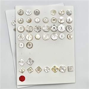 Three cards of 133 pearl and shell buttons. 
