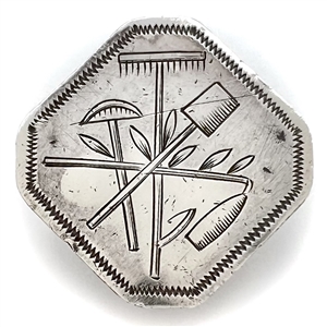 An 18th c. Silver octagon button of gardening tools.