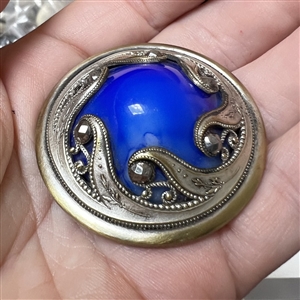 Victorian jewel button with faceted cut-steels and blue glass center.
