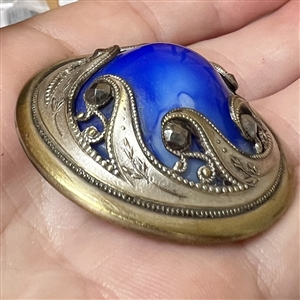 Victorian jewel button with faceted cut-steels and blue glass center.