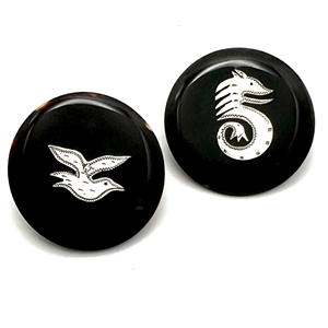 Two tortoise shell buttons with silver inlay of a sea horse and a bird.